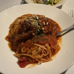 Braciole - Rolled flank steak, slow-cooked and stuffed with herbs, spices, parmesan, raisins and pine nuts.  (Fettuccini &amp; red sauce)