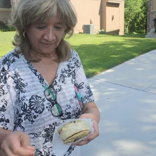 a woman holding a sandwich