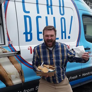 a man standing in front of a food truck