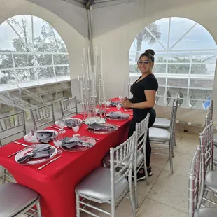 a woman setting a table for a wedding reception