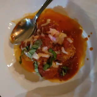 a plate of food with a spoon