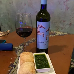 a glass of red wine and bread