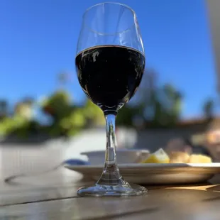a glass of wine on a table