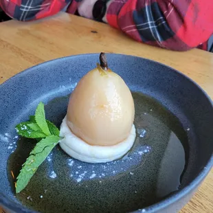 Wine poached pear with vanilla ricotta cream and pear juice reduction