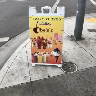 a sign on a sidewalk