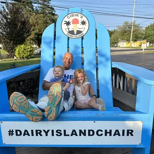 a family sitting on a dairy island chair