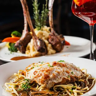 two plates of food and a glass of wine