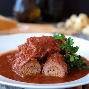 Braciole, braised flank steak cooked in a tomato wine sauce.