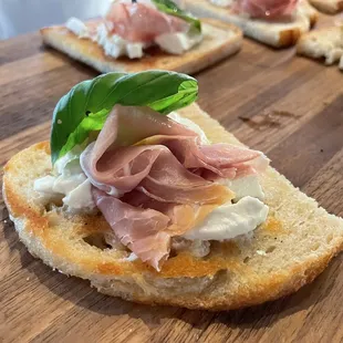 a piece of bread topped with ham and cheese