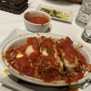 Picture: cold lasagna that I tried to heat up with a $1.50 extra cost, bowl of sauce.