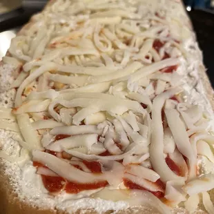 Pizza boat headed into the oven. Little upgrade from Stouffer's!