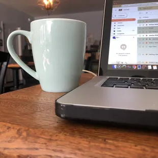 a laptop and a coffee mug