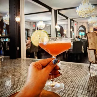 a hand holding a cocktail