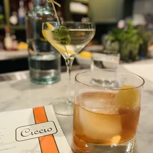 a drink and a menu on a table