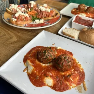 a plate of meatballs with tomato sauce