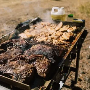 a grill with meat cooking on it