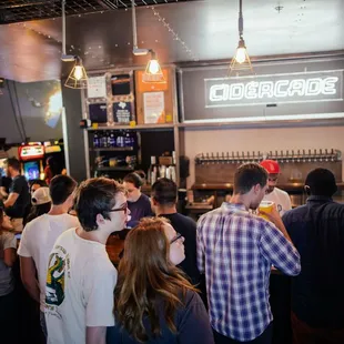a crowd of people at a bar