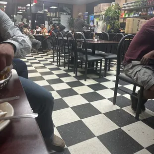 people sitting at tables in a restaurant
