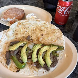 Fajita taco with avocado slices, homemade tortilla
