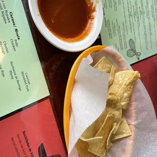 a plate of chips and a bowl of salsa