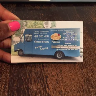 a hand holding a business card