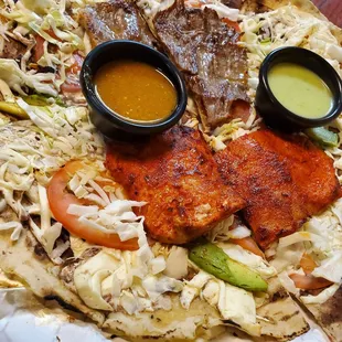 Tlayuda (large thin tortilla topped with beans, cheese, cabbage, tomato, avocado, cesina (pork) AND tasajo (steak)). SOOOOO GOOD!