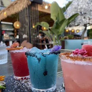 three cocktails on a table