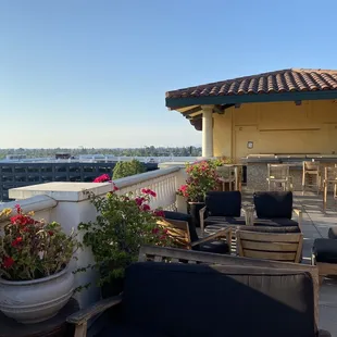 a balcony with chairs and tables