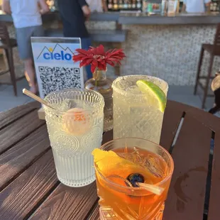 two drinks on a table with people in the background