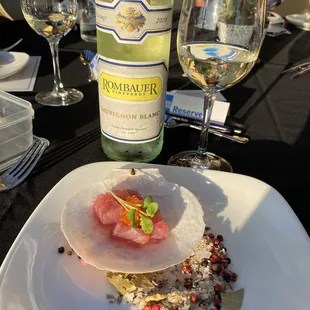 a plate of food and wine on a table