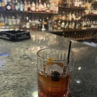 a drink in a glass on a bar