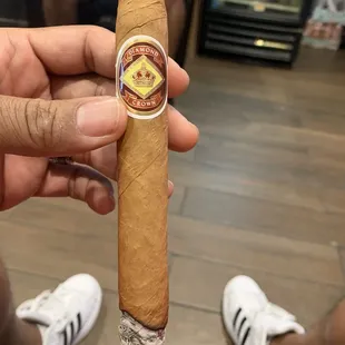 a hand holding a cigar