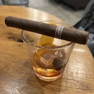  a cigar and a glass of whiskey