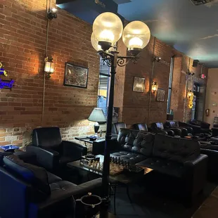 a brick wall and leather couches