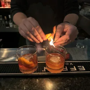 a bartender lighting a cigarette