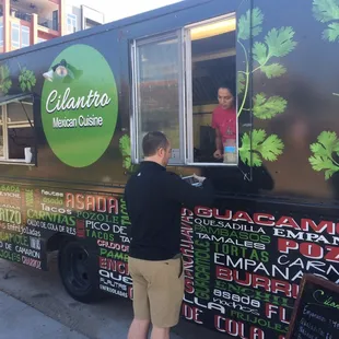 a man ordering food from a food truck