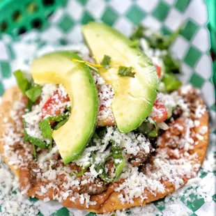 a taco topped with avocado