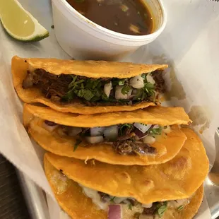 Birria taco. Very deceptive that they put the most meat in the top taco and barely anything in the bottom two. Also, where's the cheese?