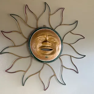 a sun face on a wall