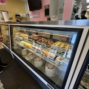 a display case filled with cakes