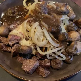 Flat iron steak, onions mushrooms over potatoes