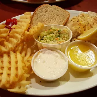 Baked haddock with waffle fries, and melted butter.