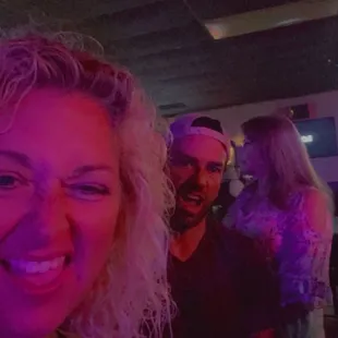 a woman with blonde hair smiling at the camera