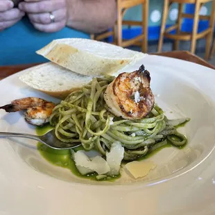 a plate of pasta with shrimp and asparagus
