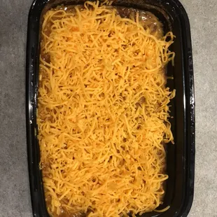 Cincinnati Chili Company chili dip with cream cheese, chili, onions and shredded cheddar cheese.