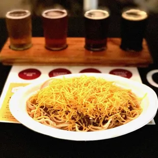 a plate of spaghetti and beer