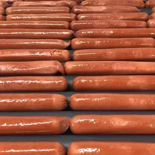 rows of hot dogs on a conveyor belt