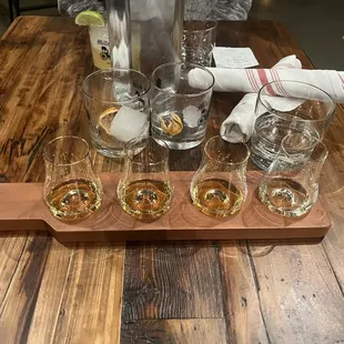 a variety of glasses on a wooden table