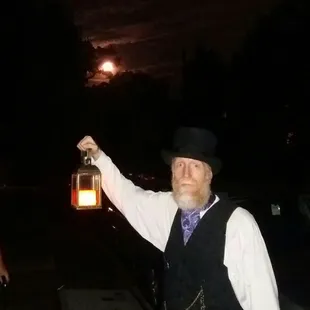 A full harvest moon, partially shrouded by clouds and our illustrious host. #CincinnatiGhostTour