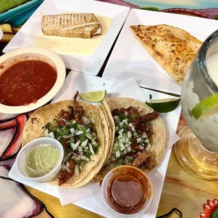 Al Pastor tacos, ground beef Chimichanga, cheese quesadilla, salsa, frozen margs. All our favs
